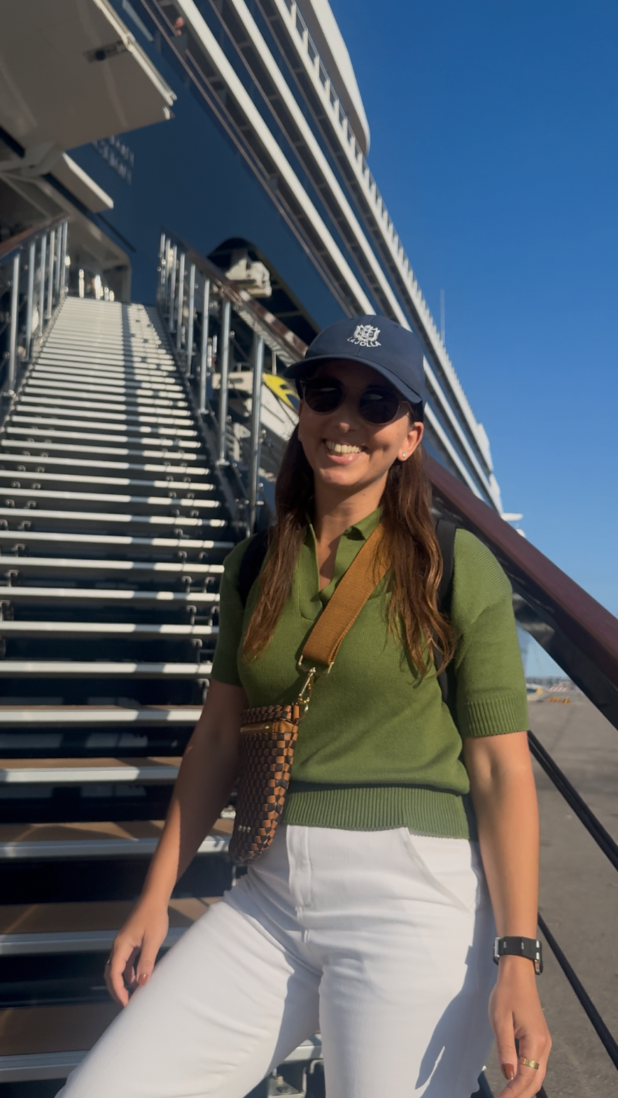 Alex boarding a ship, smiling on the gangway stairs